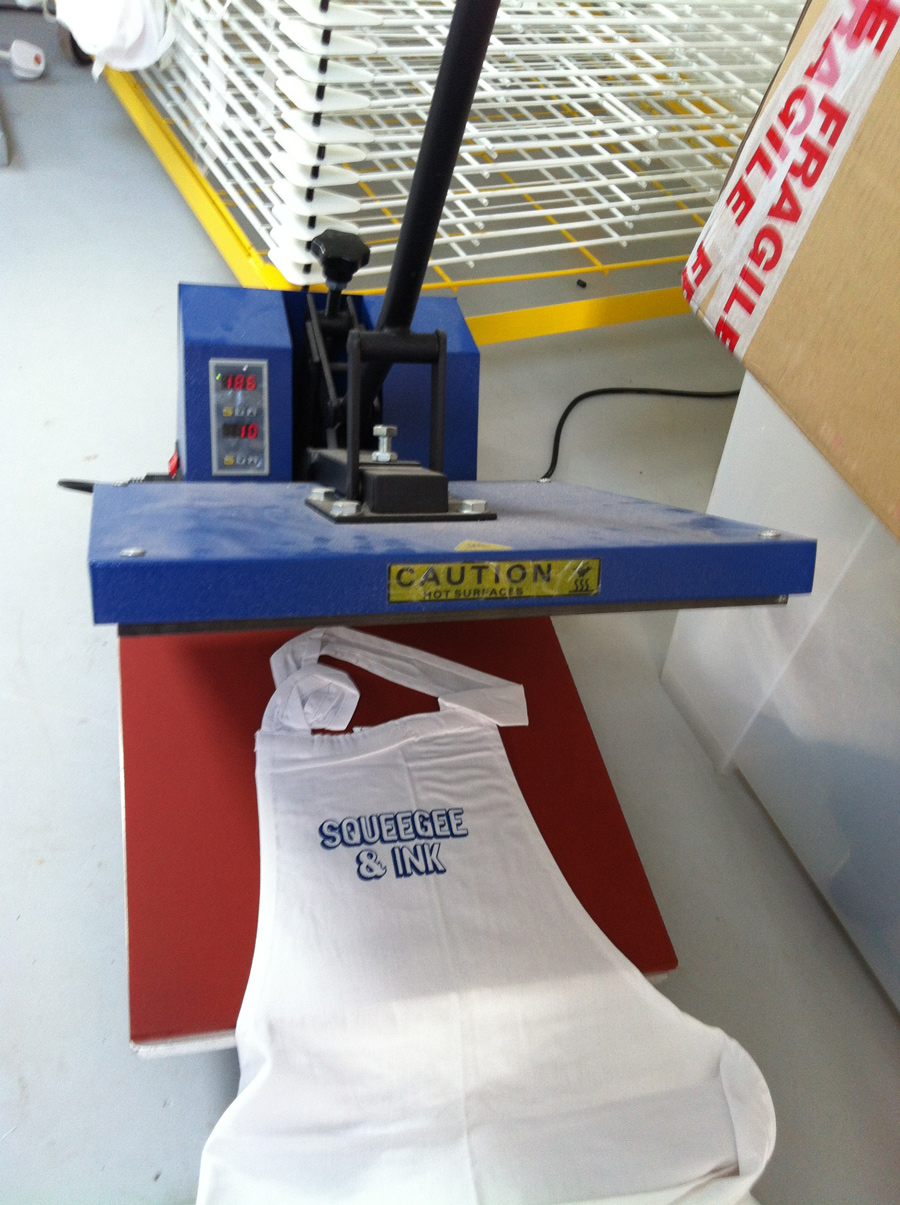 Photo of an apron on which a logo has been transferred using a heat press